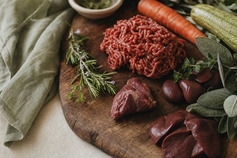 Raw beef mince and organ meat on a wooden board, ideal raw dog food for cavoodles diet