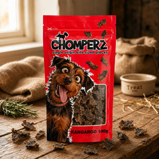 Chomperz Kangaroo Jerky 100g pack of air-dried Australian kangaroo dog treats on a wooden table with scattered jerky pieces